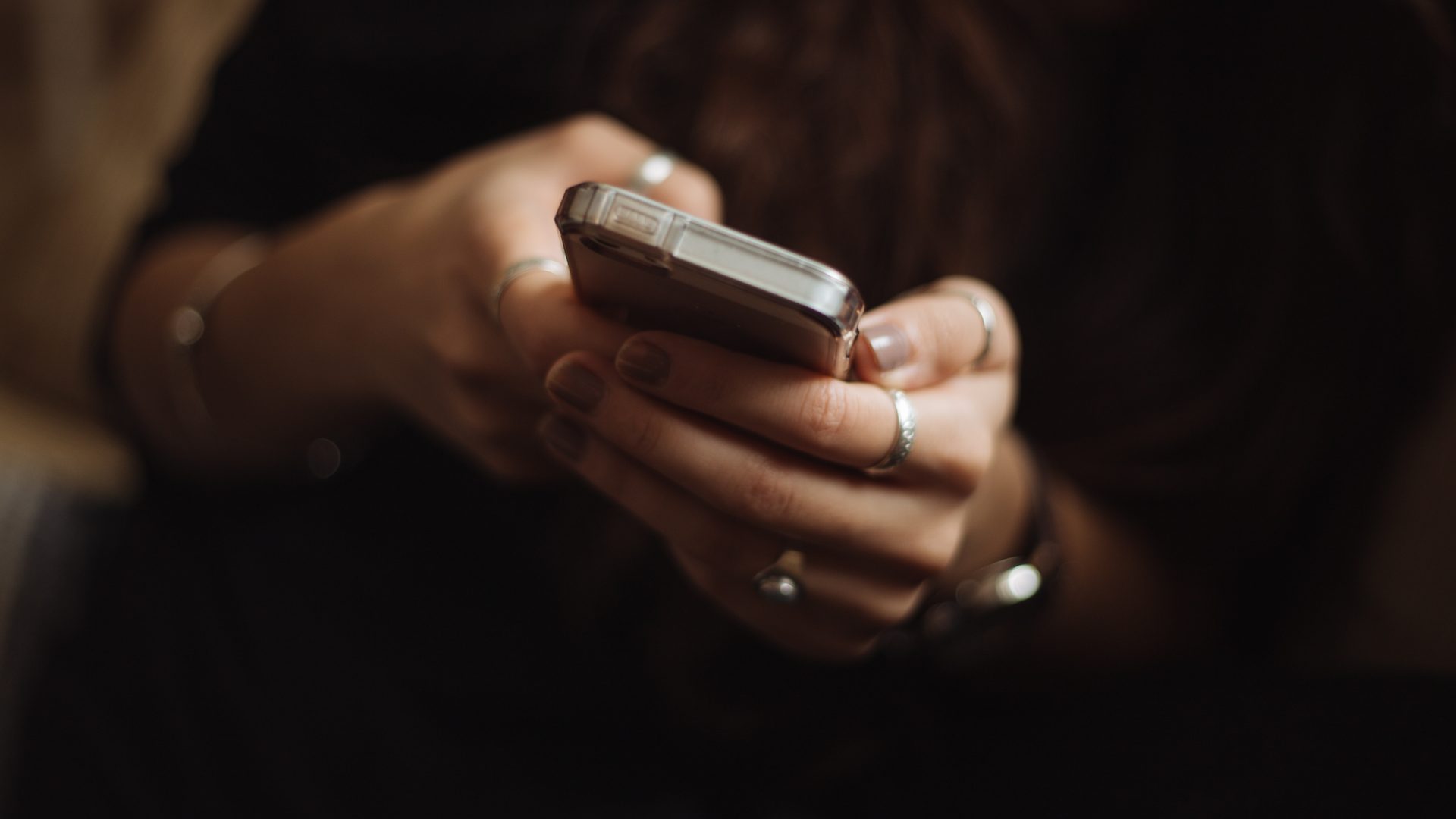 Close-up image of a person using a smartphone.