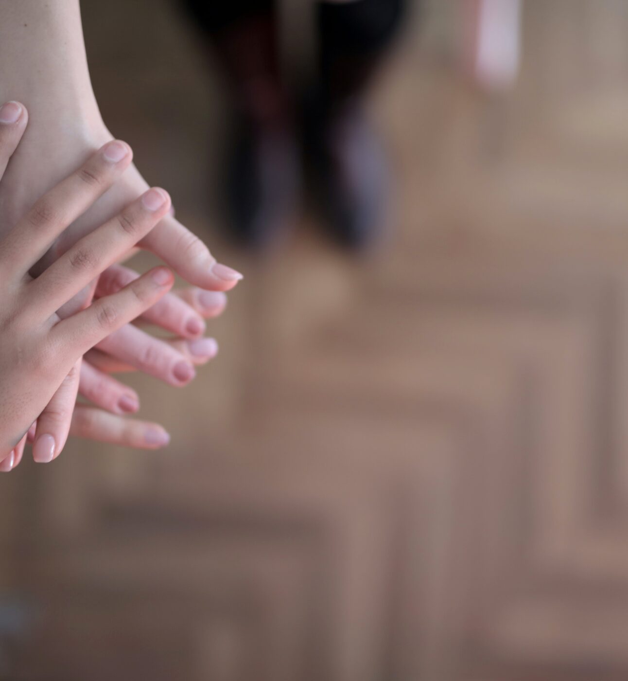 three people joining hands